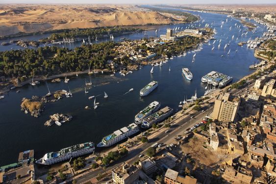 Aerial view of a river with boats and buildings along its banks.